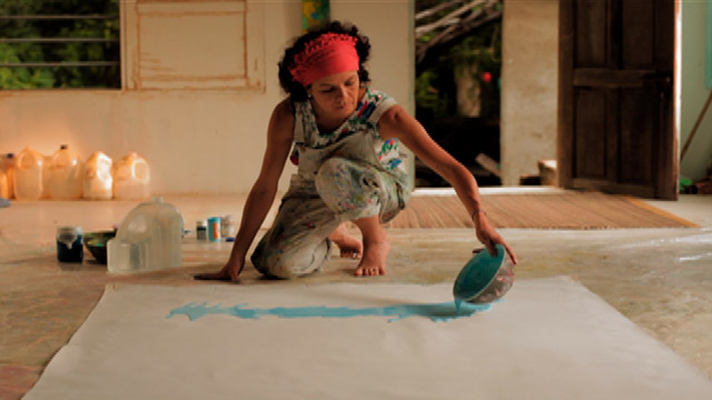 Artista derramando pintura sobre un papel